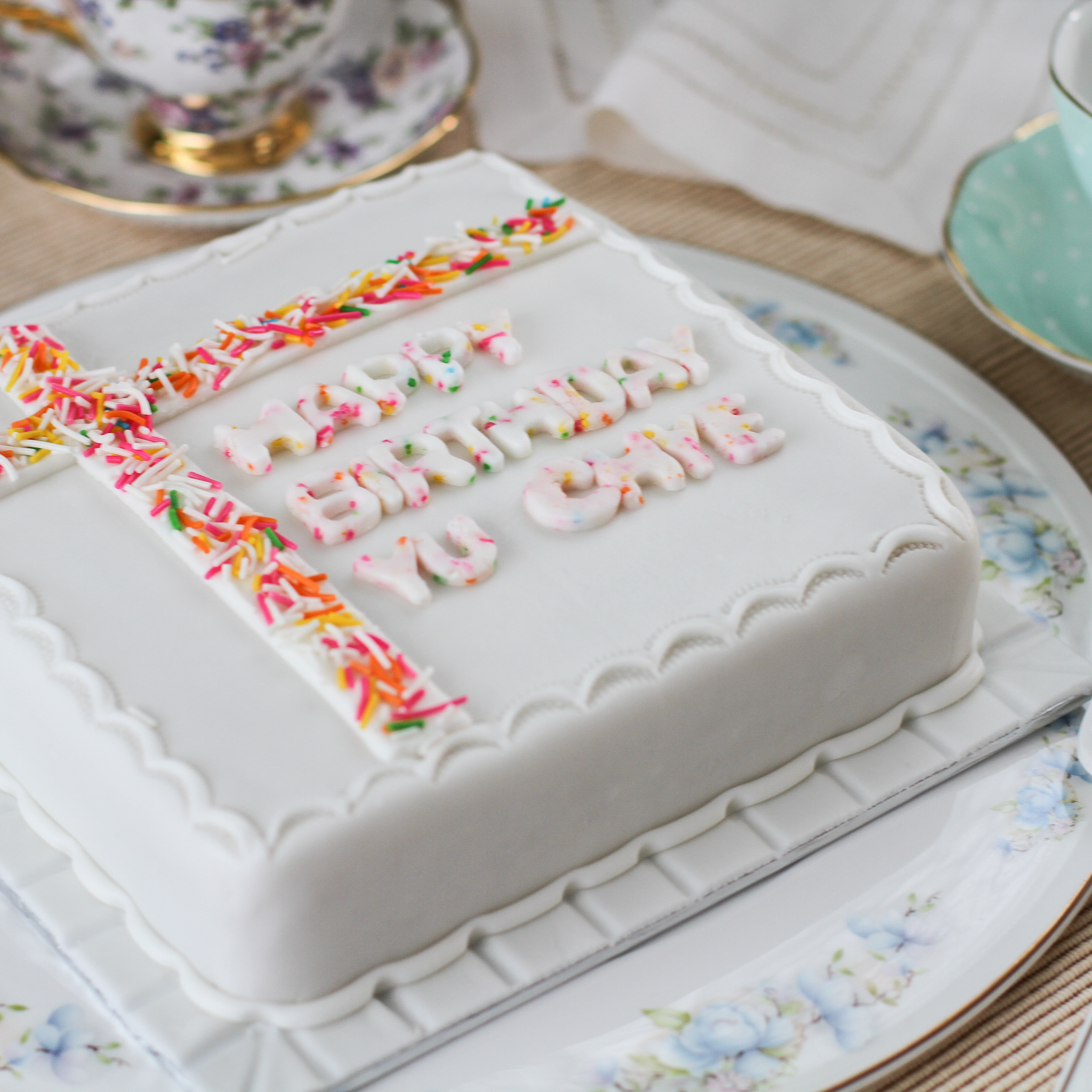 An iced sugee birthday cake with marzipan and fondant